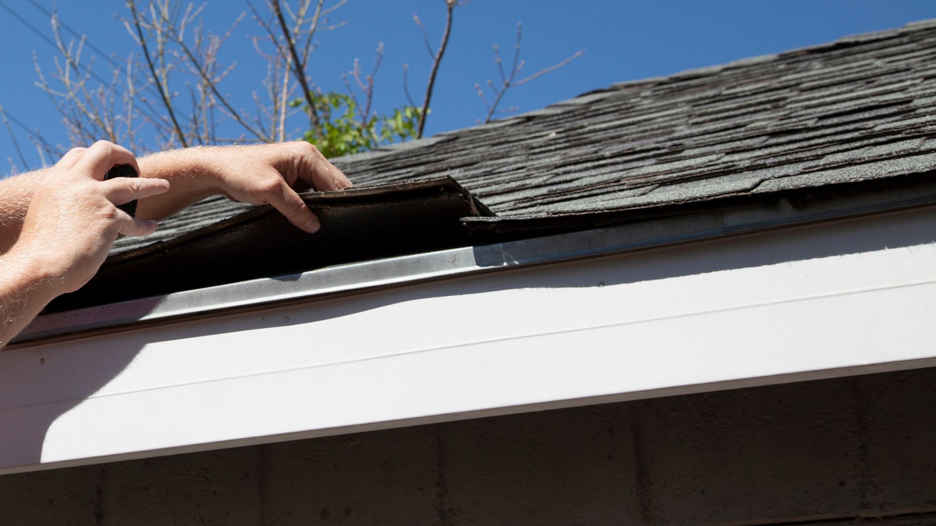 A person is working on the roof of a house