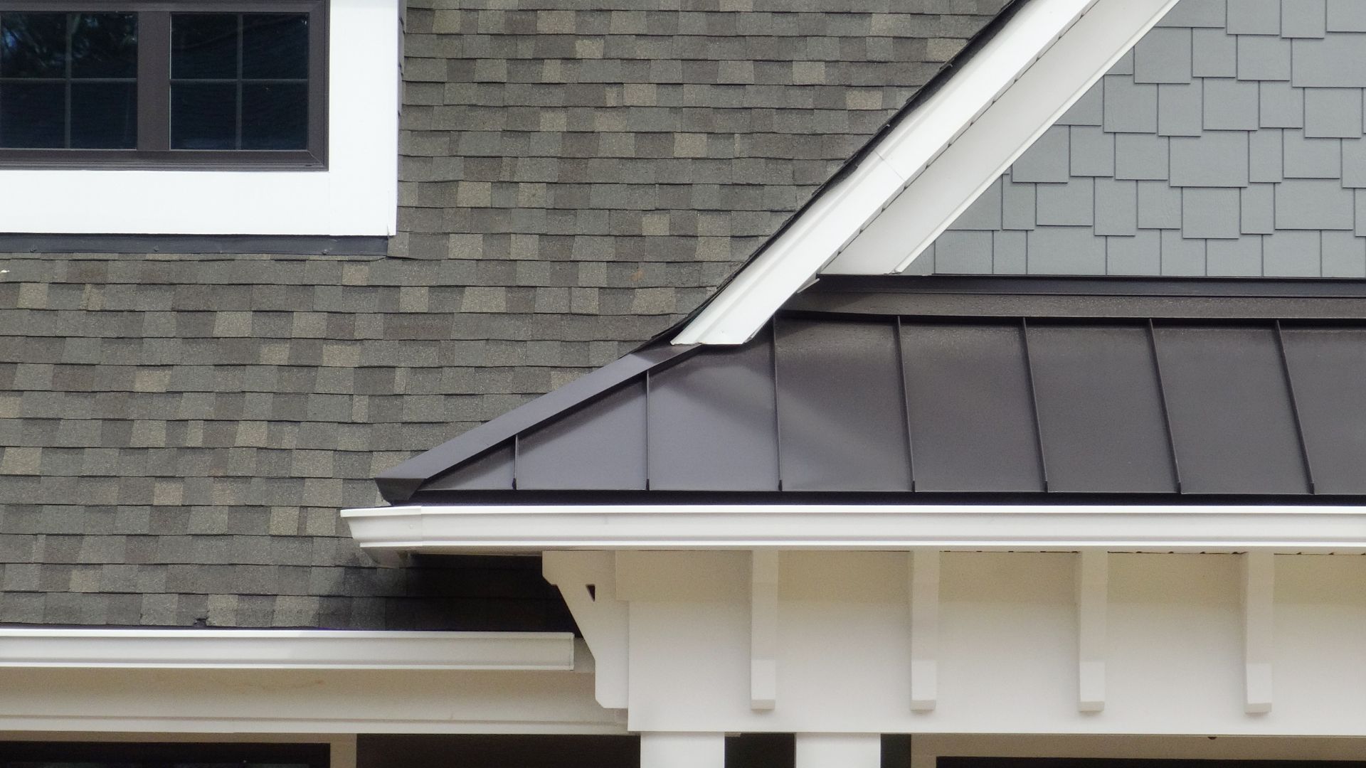 A close up of a roof with a clock on it