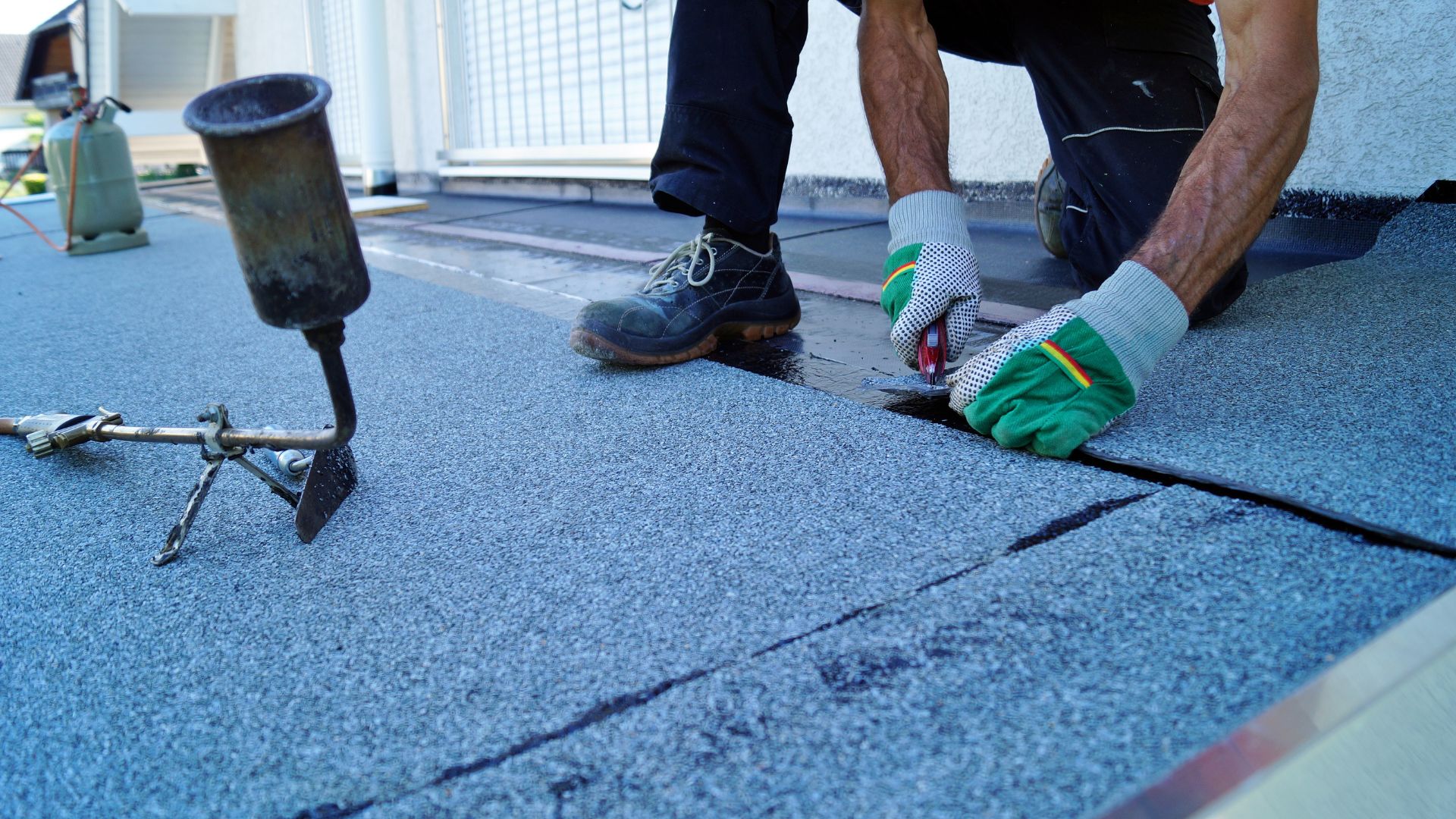 A man working on a roof with a hammer