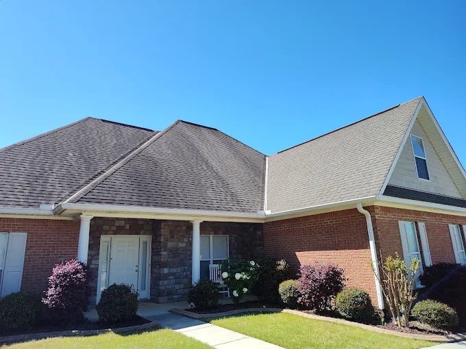 Brick ranch-style home with stone accents and landscaped front yard